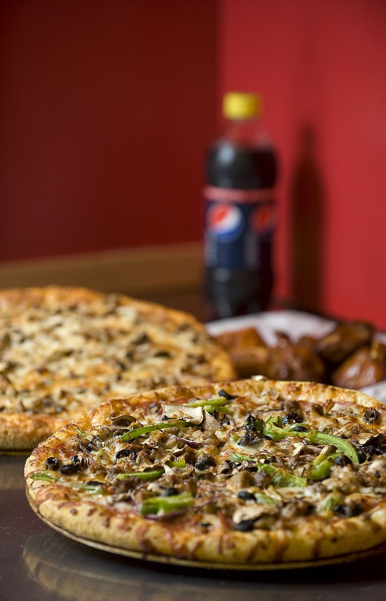 Vancouver-based Blazzin Pizza offers the Blazzin Supreme pizza, clockwise from bottom, Mark's Inferno Pizza and a side of regular wings at both its Cascade Park and new Hazel Dell-Salmon Creek locations.