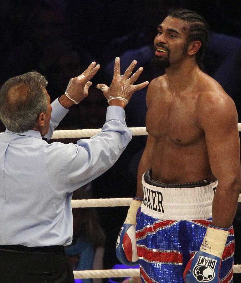 Referee Genaro Rodriguez gives a standing eight count to David Haye.