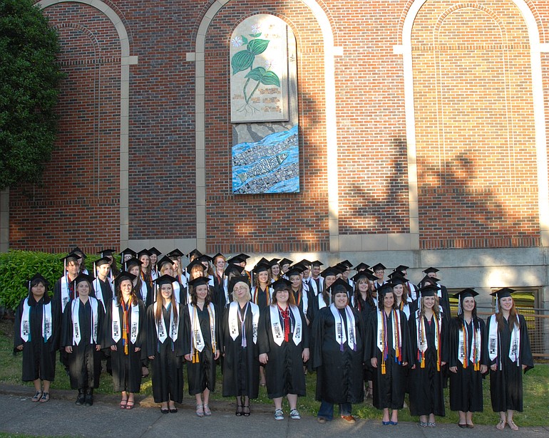 Vancouver School of Art and Academics 2011 graduating class members stand in front of a mural recently installed at the school and dedicated in their honor.
