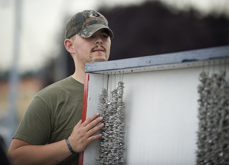 Carl Loomis, 25, of Gresham, Ore., sets up the &quot;High Cost of Freedom&quot; display representing 1.3 million American soldiers who have died in conflicts since the Revolutionary War.