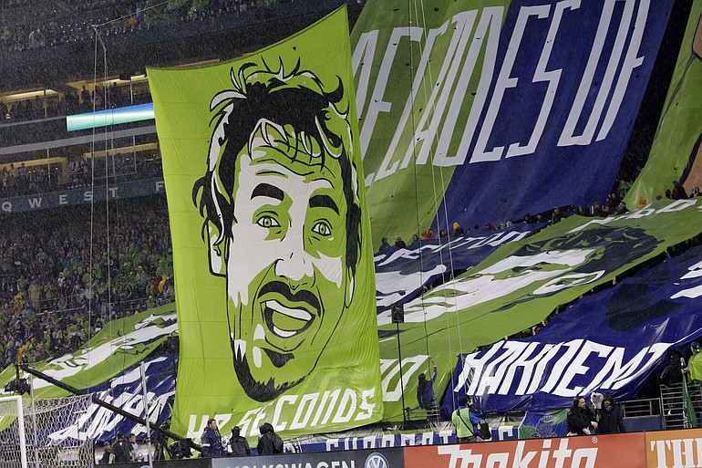 Seattle Sounders FC supporters display a giant banner of Sounders player Roger Levesque, who will likely be the target of boos from Portland Timbers fans when the Sounders visit Portland on Sunday.
