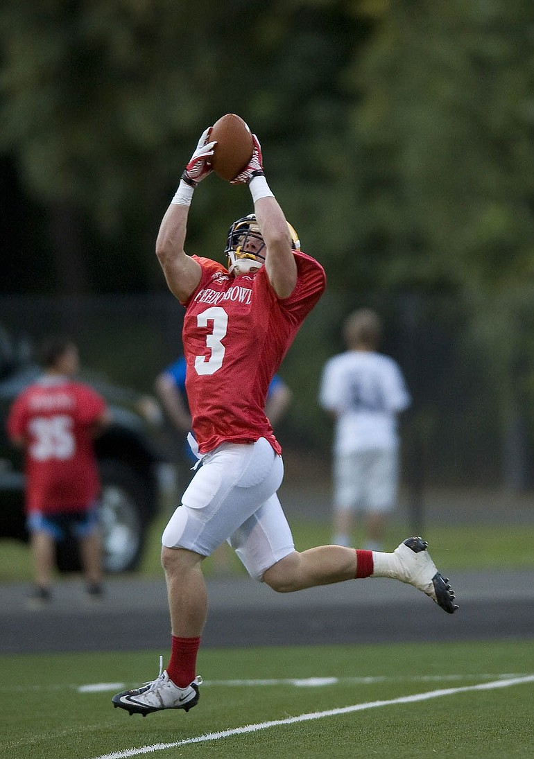 Columbia River High School graduate Kevin Cotter (3) of the West team hauls in a pass from Kimothy King of Hudson's Bay for a 48-yard touchdown pass to tie the game at 7 early in the second quarter.