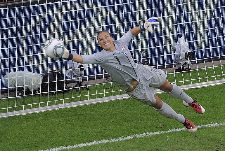 United States goalkeeper Hope Solo deflects a penalty shot during the quarterfinal match between Brazil and the United States at the WomenIs Soccer World Cup in Dresden, Germany, Sunday, July 10, 2011.