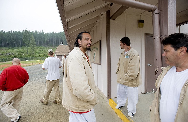 William Thayer, center, and other inmates at the Larch Corrections Center gather outside the mess hall.