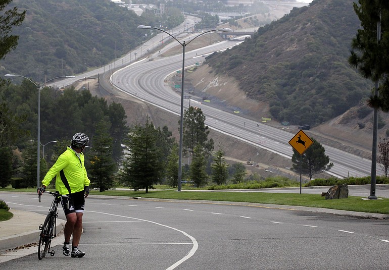 Jerry Wenker watches Interstate 405 during the freeway closure in Los Angeles on Saturday.