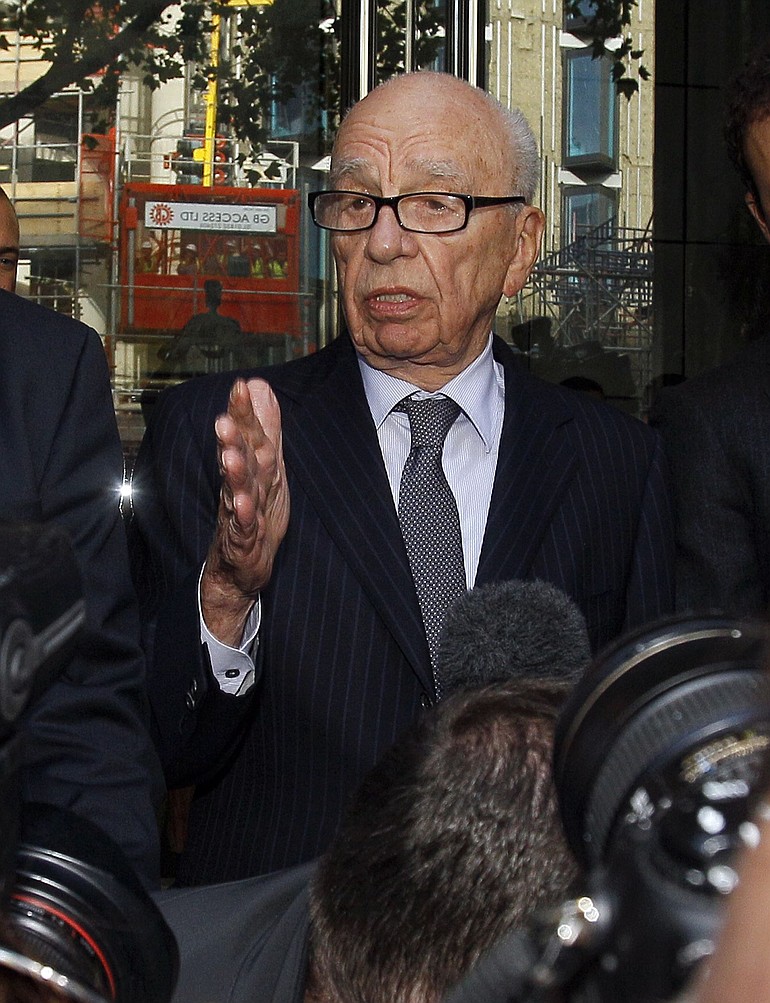Rupert Murdoch attempts to speak to the media Friday after he held a meeting with the parents and sister of murdered school girl Milly Dowler in London.