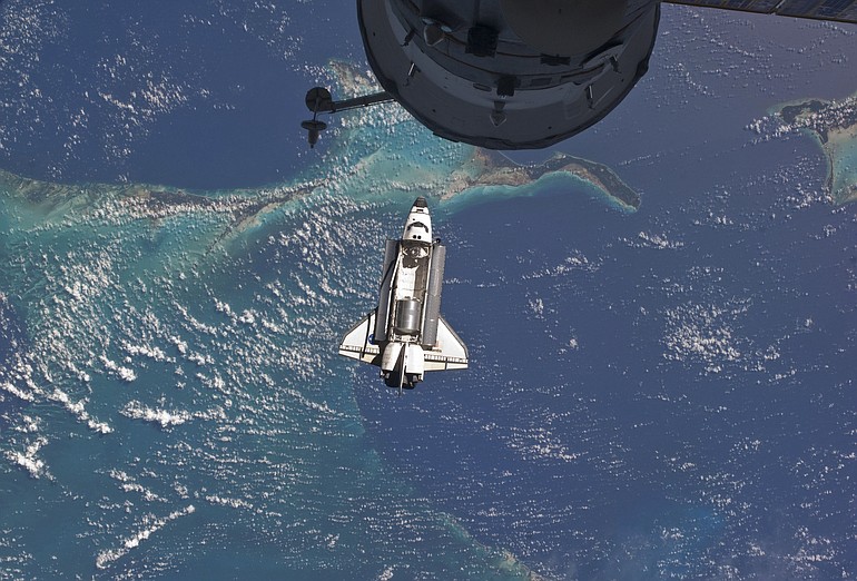 The space shuttle Atlantis is seen over the Bahamas prior to a perfect docking with the International Space Station on July 10.