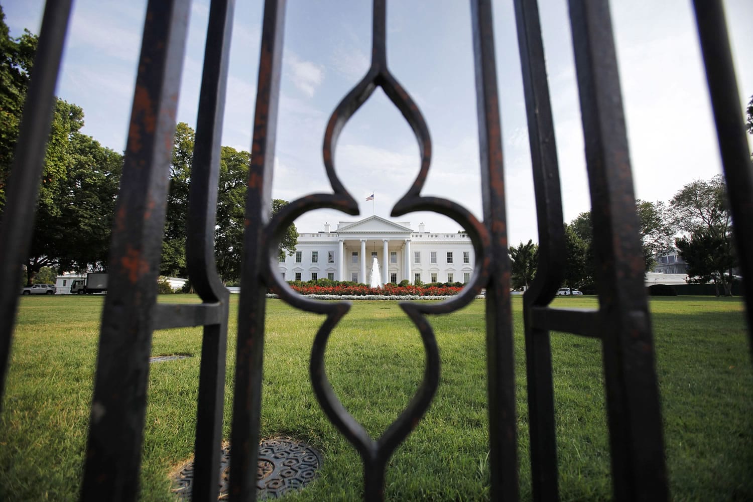 The White House is seen through the fence from Pennsylvania Avenue as debt talks continue in Washington, on Sunday.