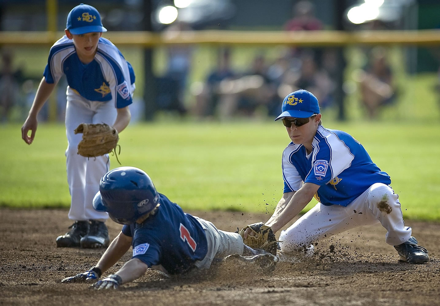 Salmon Creek's Casey Marin tags Spokane's Michael Thew at second base for the out in the first inning Sunday.