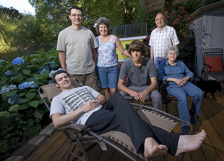 Loren and Laurie Sickles, back left, and their two sons, Caleb, 17, foreground, and Brandon, 14, center, moved in with Loren's parents, Larry, 75, and Lois Sickles, 70, right, after Loren lost his job and the family was forced to sell their home.