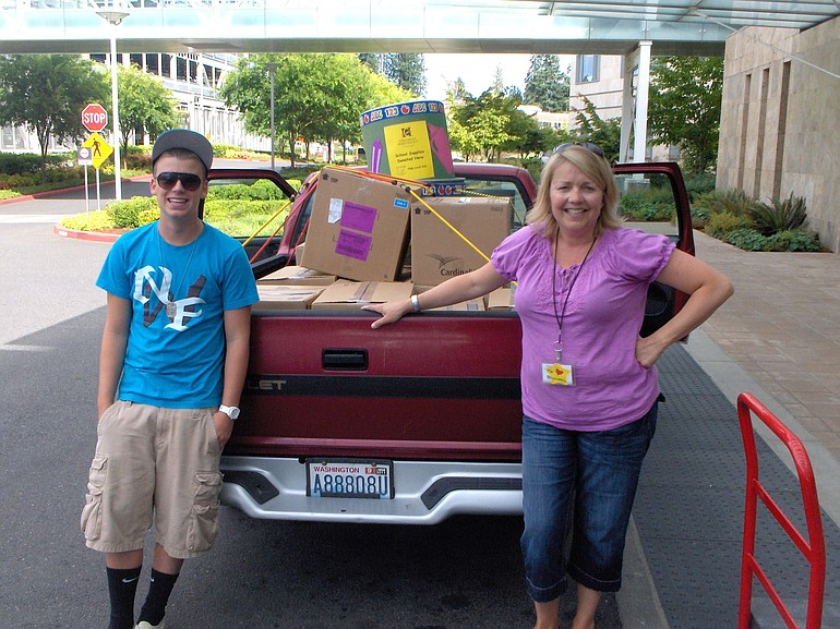 Salmon Creek: Cara Larson, a family educator with Children's Home Society of Washington, stands by a truck fully loaded with 13 boxes of school supplies donated by employees of Legacy Salmon Creek Medical Center. The supplies will be given to Clark County children and families served by Children's Home.