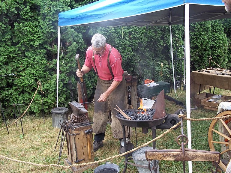 Washougal: Gary Lewis demonstrates the work of a forger.