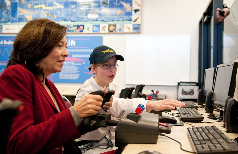 Pearson Air Museum volunteer Kaya Galbraith, 13, guides U.S. Sen. Maria Cantwell, D-Wash., on a simulated flight Tuesday from Portland International Airport to Troutdale, Ore. Cantwell visited the Vancouver museum for a discussion on how to maintain U.S.