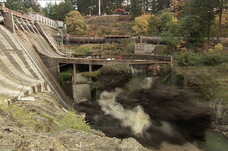 A remote video camera captures the force of a massive explosion as it breaches Condit Dam shortly after noon Wednesday, releasing the White Salmon River for the first time since the dam was built in 1913.