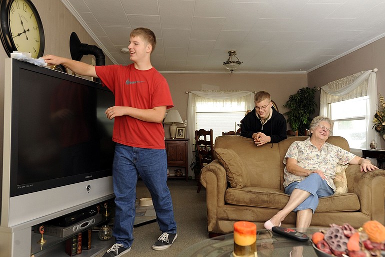 Marty Embleton, right, chats with her grandsons, Nick, left, and Alex Embleton at their home in Vancouver.