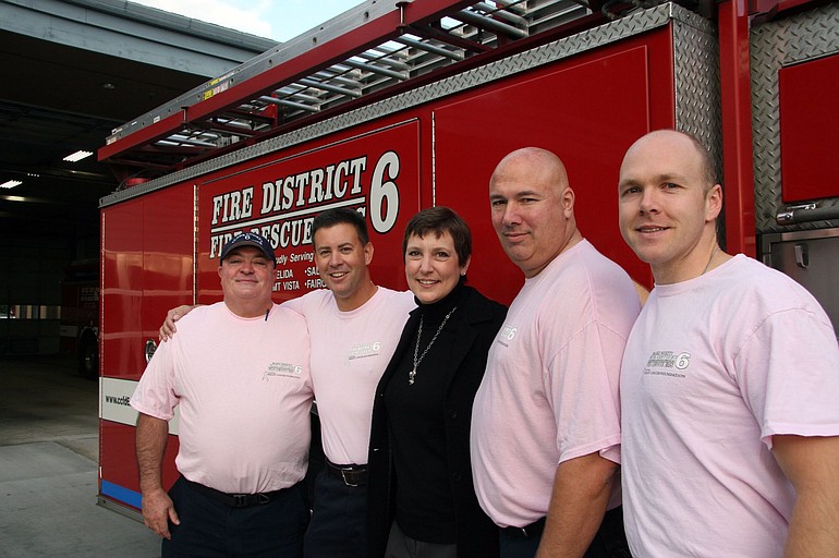 Northeast Hazel Dell: Clark County Fire District 6 firefighters show off their pink shirts in honor of Breast Cancer Awareness Month. From left, Firefighter Bob Hamel, Capt.