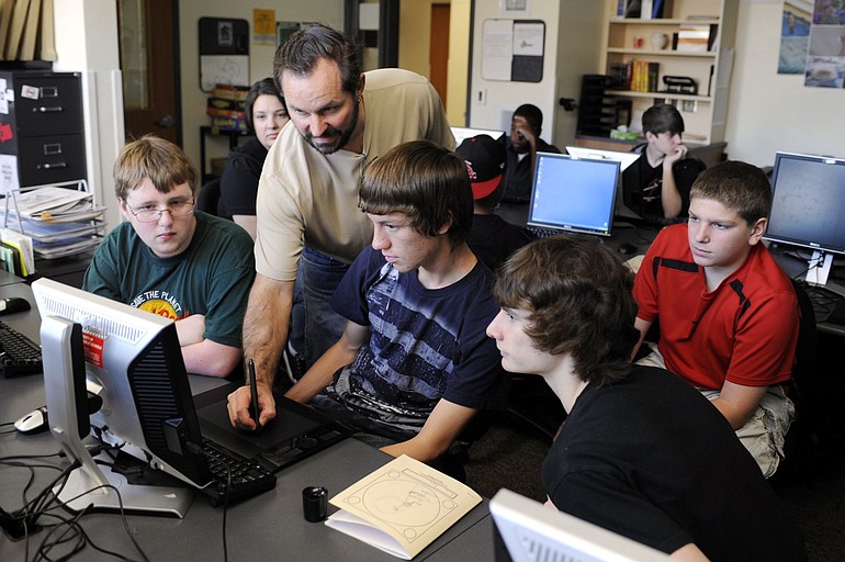 Joseph Sliger, with beard, an applications specialist for Wacom, demonstrates the use of the pressure-sensitive digital pen on one of several newly purchased Wacom computer tablets to Union High School students, from left, Russell Beaver, Austin Klein, Aaron Siegel and Trey Cornish.