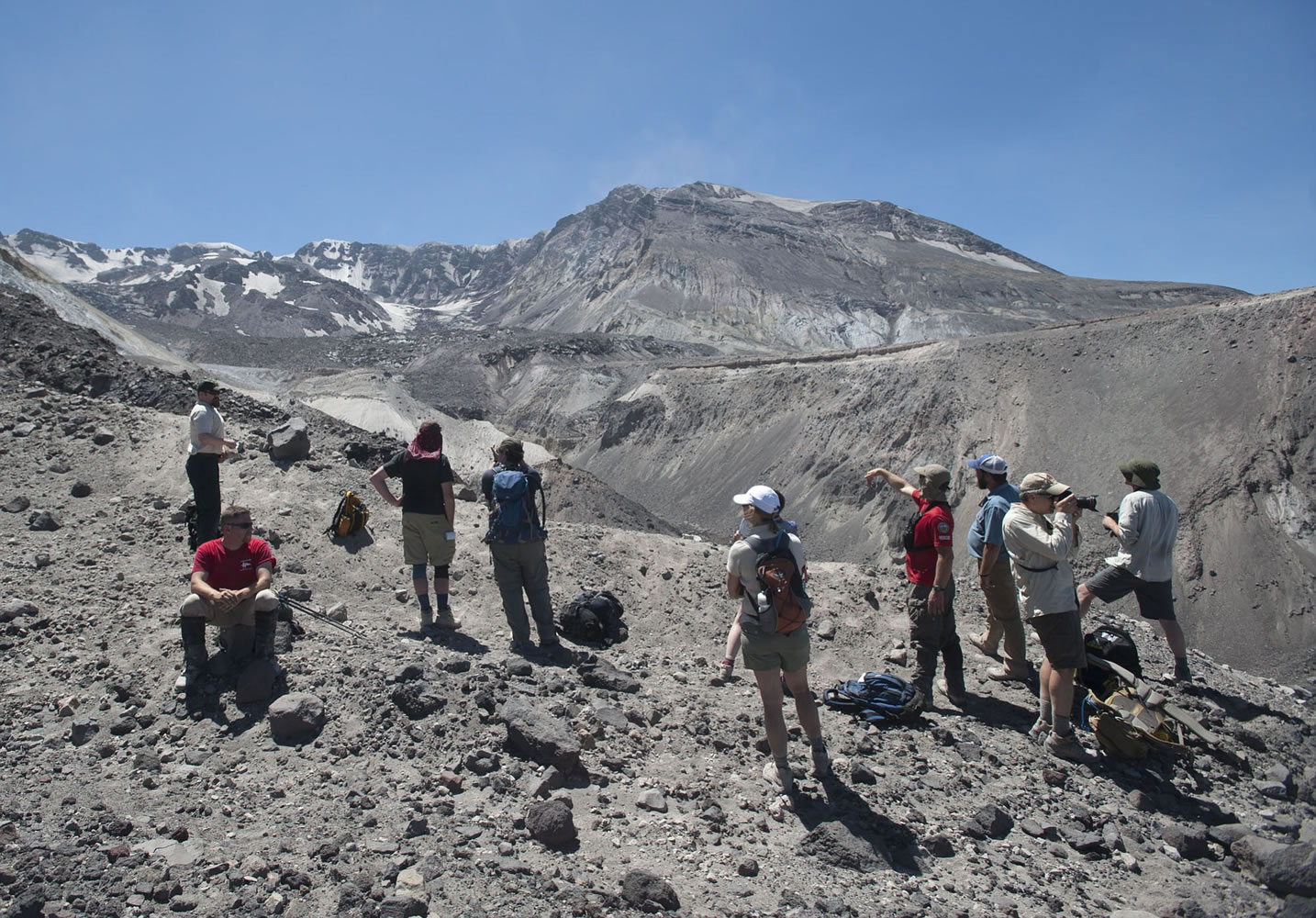 A group of journalists and other hikers stand near the rim of Mount St. Helens' crater recently. The Mount St.