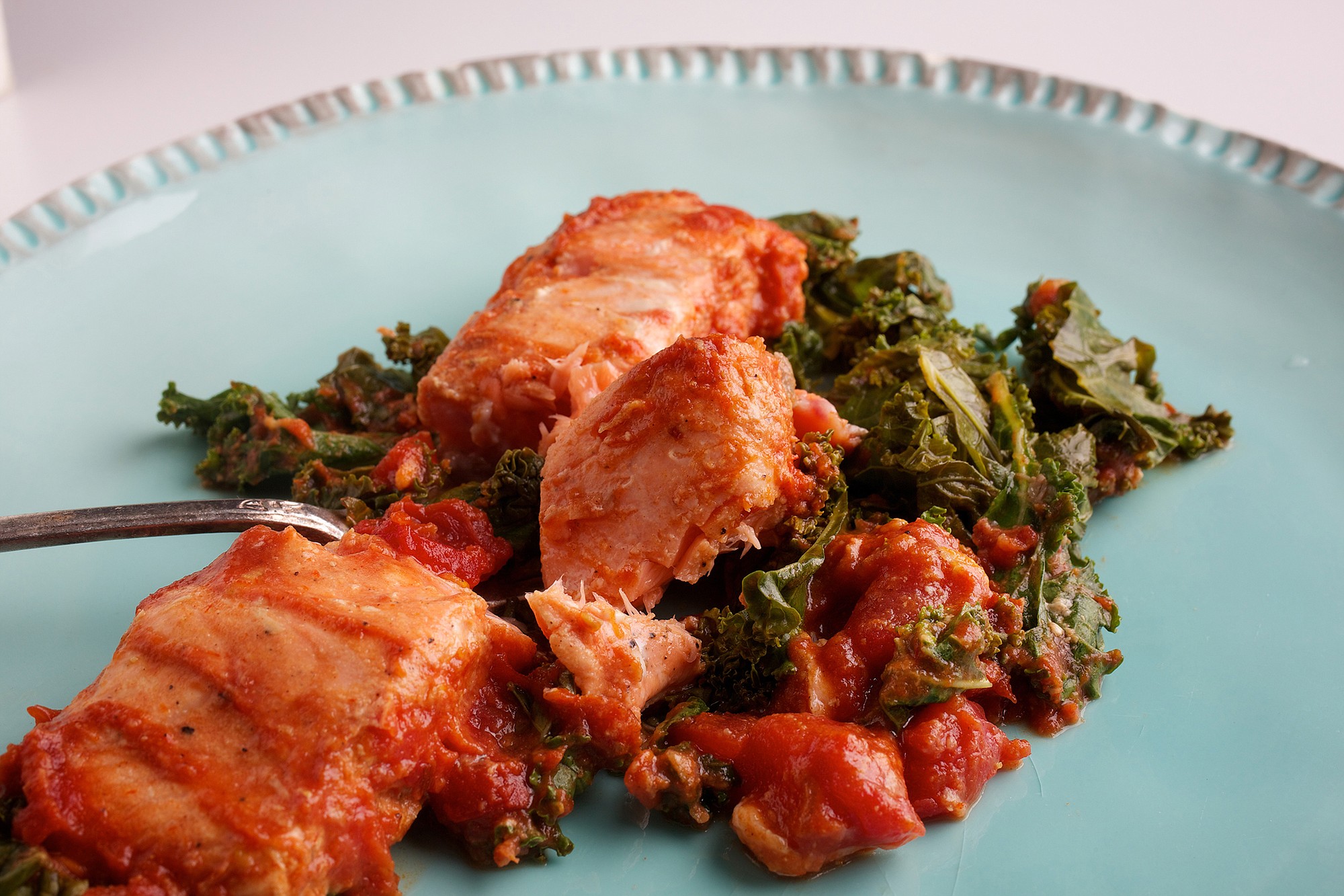 Baked Salmon and Kale in Moroccan-Spiced Tomato Sauce.