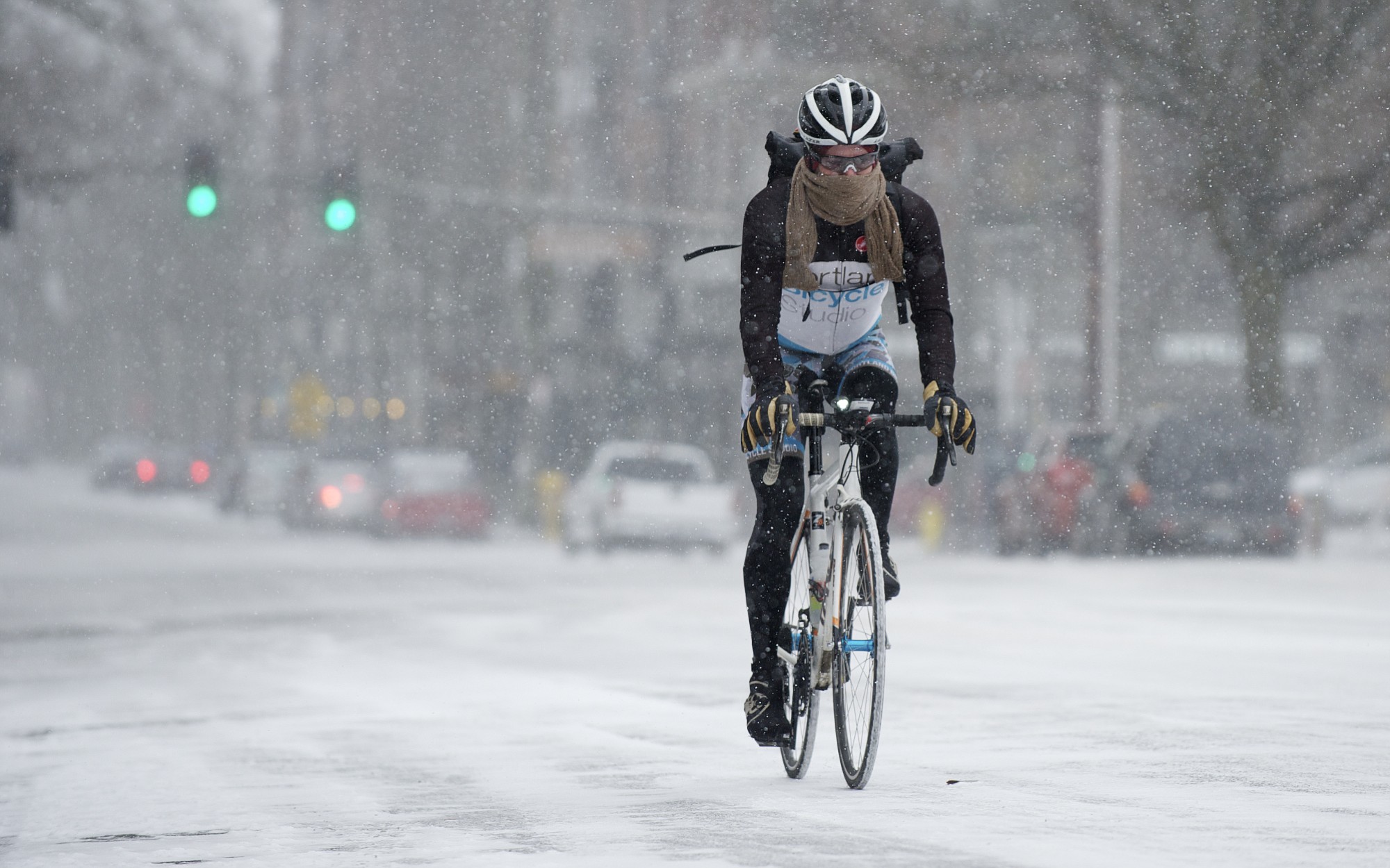 Kevin Drake rides his bike along W. 8th Street near Main Street in downtown Vancouver, as he commutes to work in Camas, Thursday, February, 6, 2014. Several inches of snow is expected to accumulate in the Portland-Vancouver metro area.