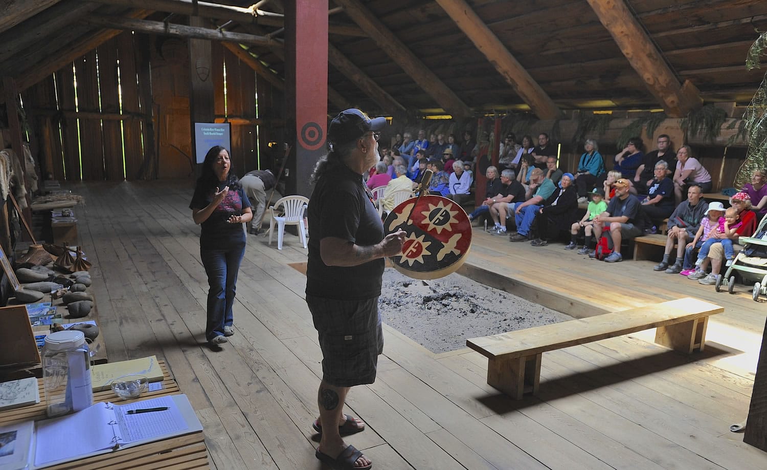 Sam Robinson, center, acting chairman of the Chinook Indian Nation, beats a drum and sings a traditional song of blessing Sunday at the Cathlapotle Plankhouse in Ridgefield before a presentation about native women's views of Lewis and Clark.