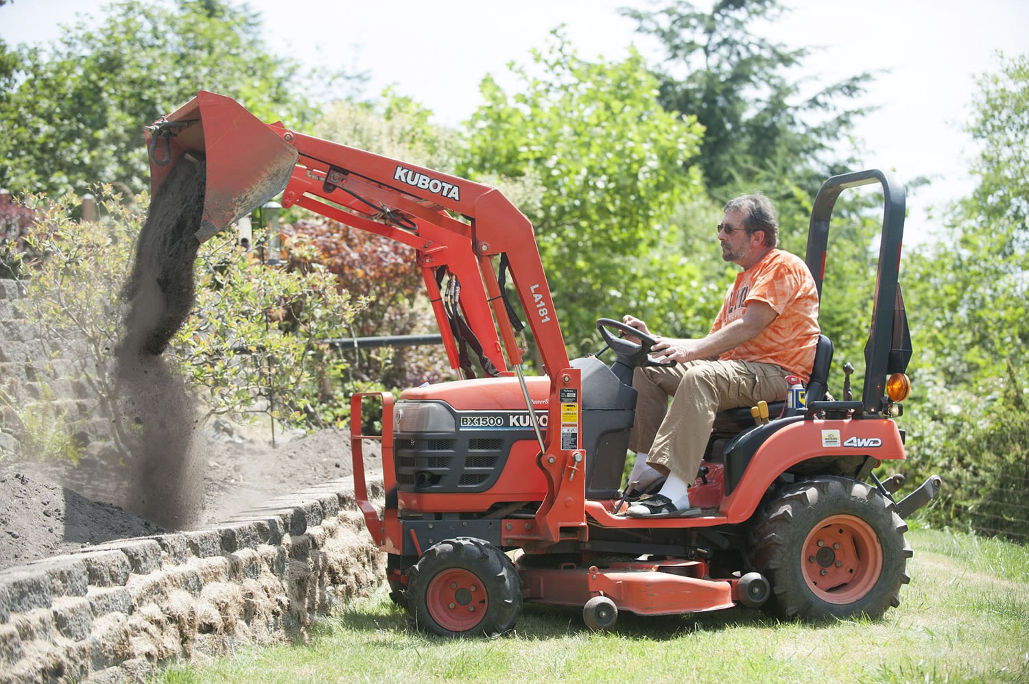 Rick Dobson uses a tractor to work in his yard at his home in Kalama.