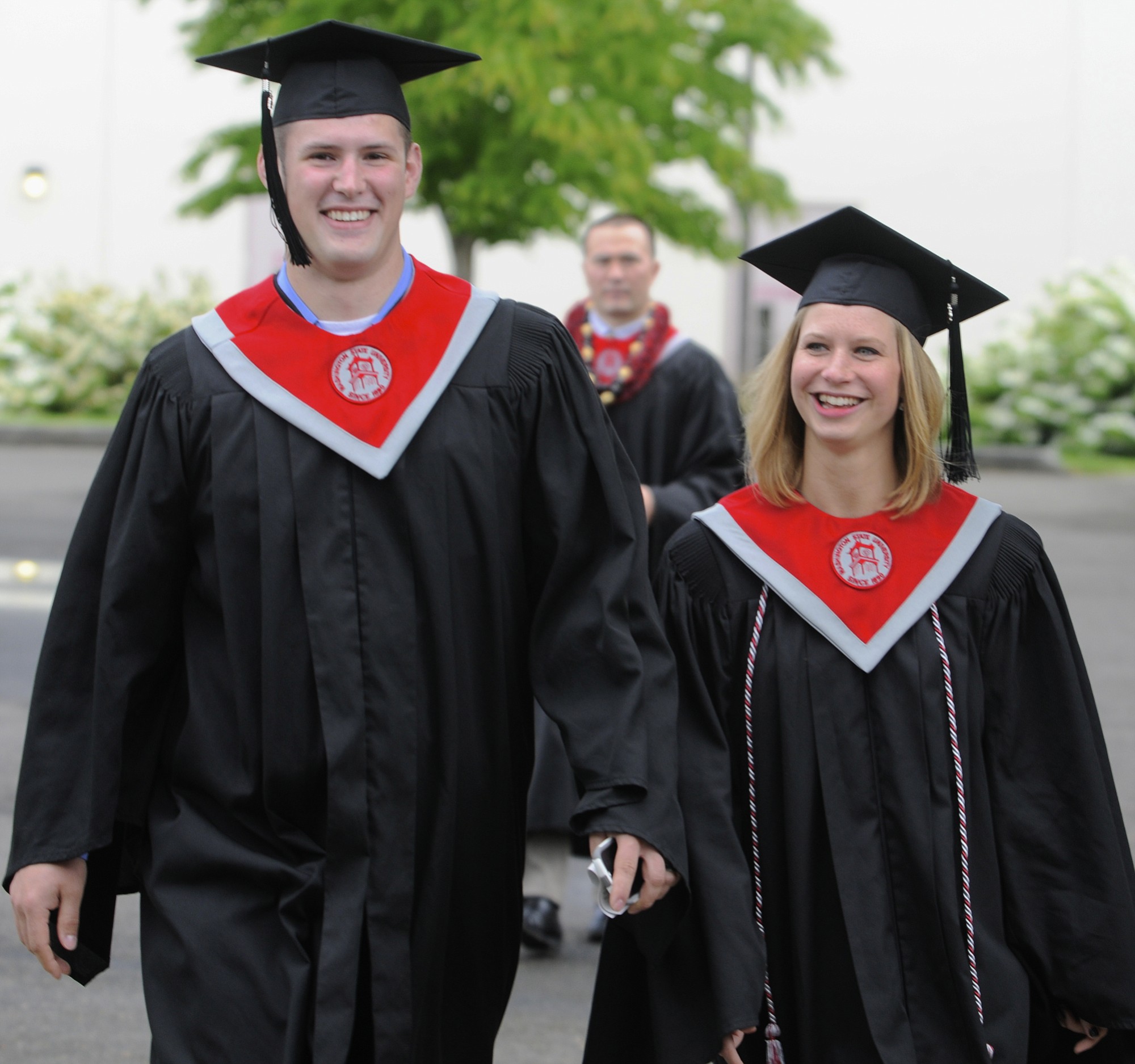 Washington State University's 2014 graduates Zach and Kendall Nielsen together prior to their commencement ceremony Saturday in Ridgefield.