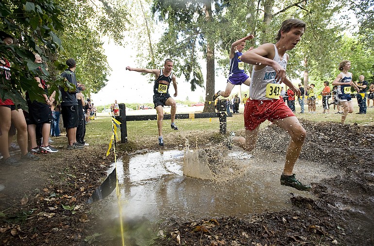 Nate Starr, #343, a senior from Mark Morris High School, leads the varsity boys through the mud pit Friday at the 50th annual Run-A-Ree cross country meet at Hudson's Bay High School.