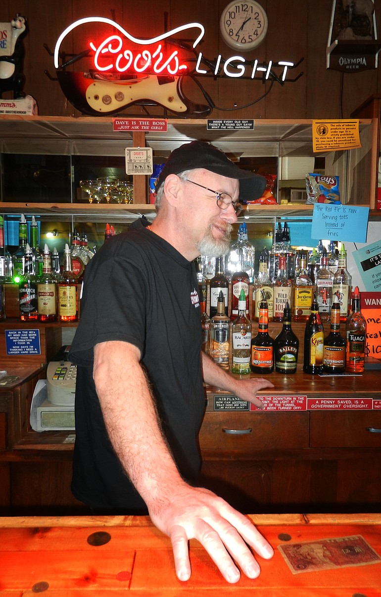 Dave Ayers tends bar Friday at his place of business, Red Fir Inn, in Yacolt.