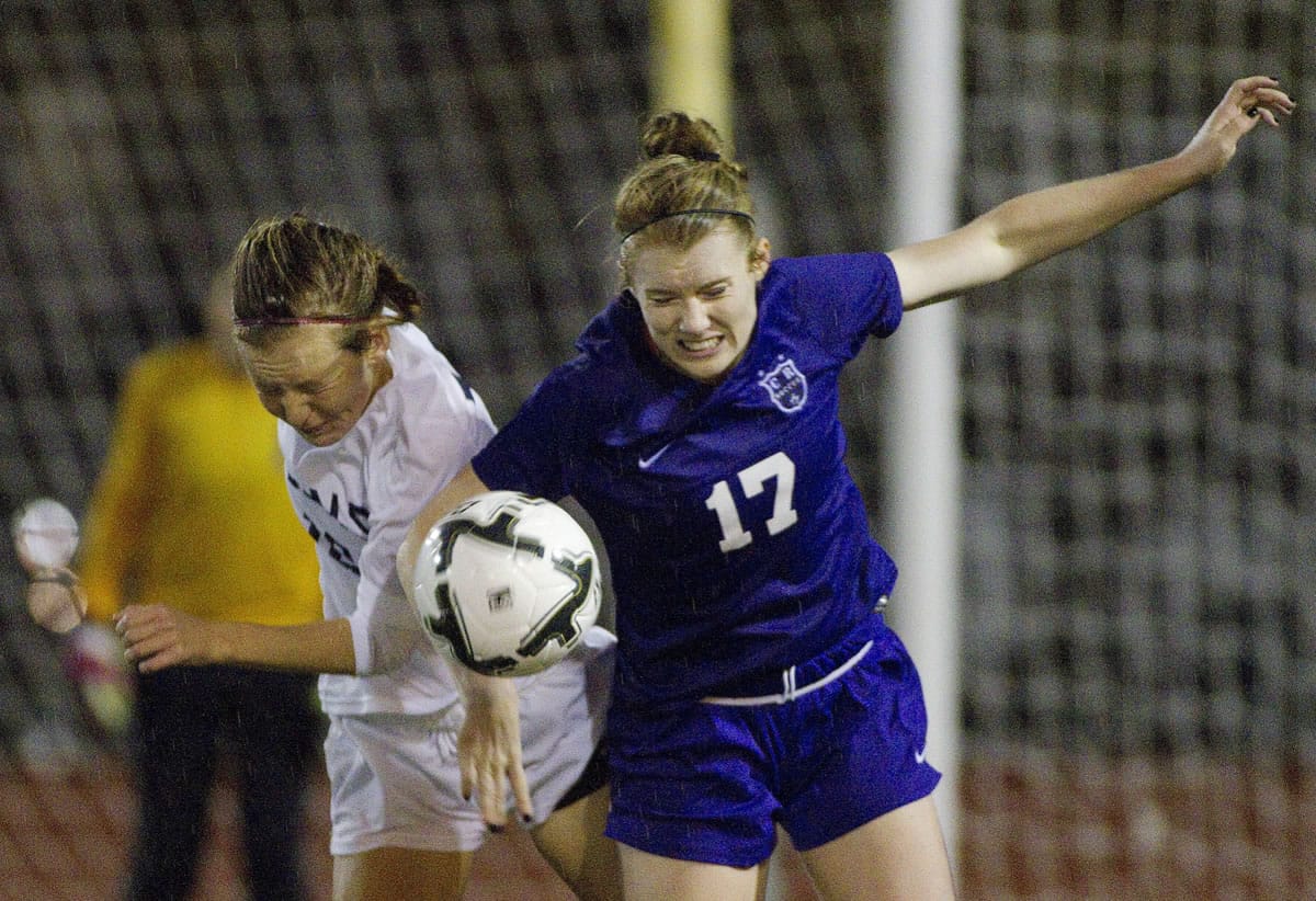 Columbia River's Katie Anthony, right, and Southridge's Syd Sanders battle for the ball during action in their rainy semifinal match in the 3A state girls soccer championships in Puyallup.