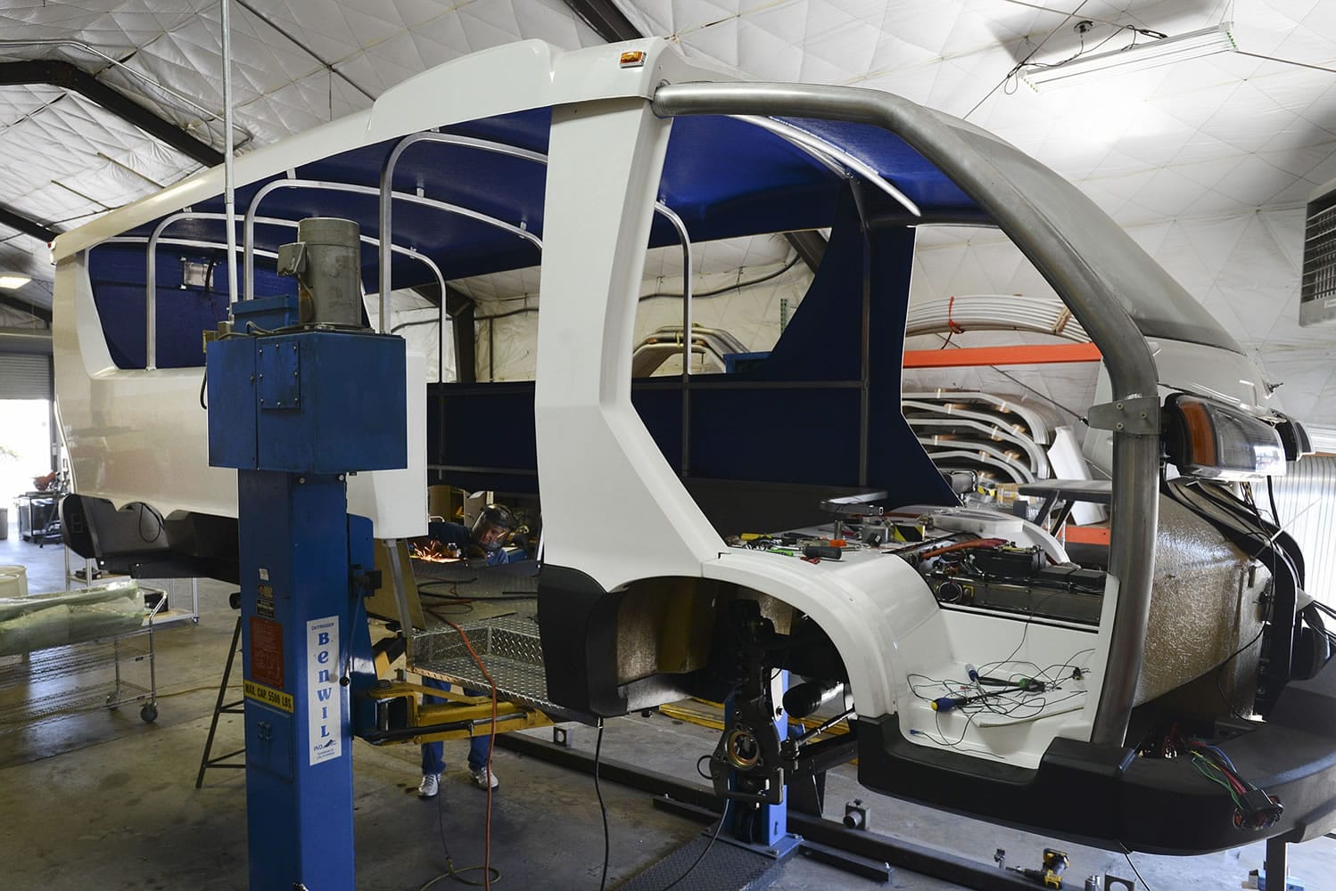 Pangea Motors continues to fine tune its World Bus at its manufacturing garage at 915 Jefferson St.