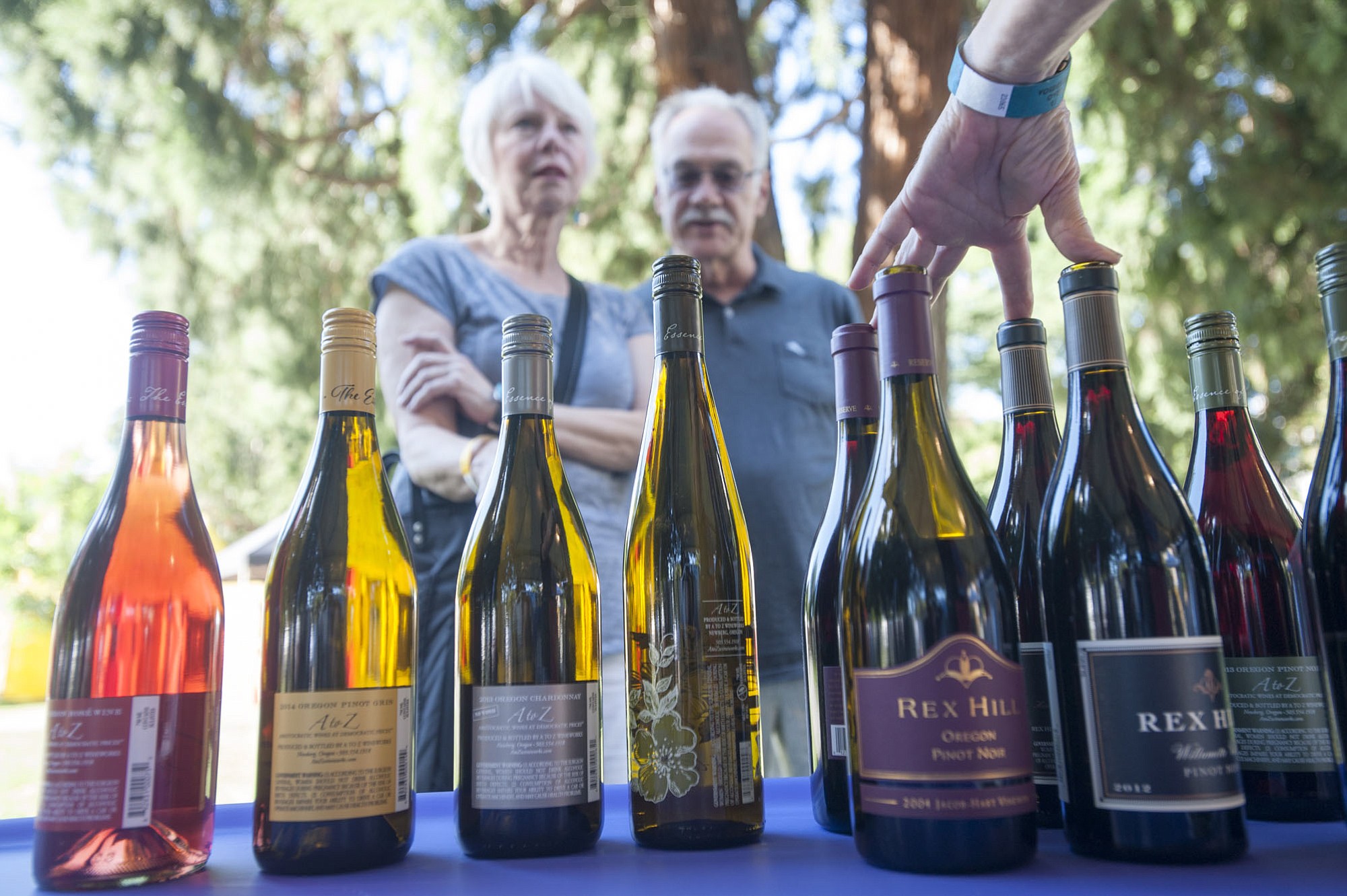 Leatha Tehennepe and Bill Hilleary pick out a wine at the Vancouver Wine and Jazz Festival at Esther Short Park in downtown Vancouver on Friday.