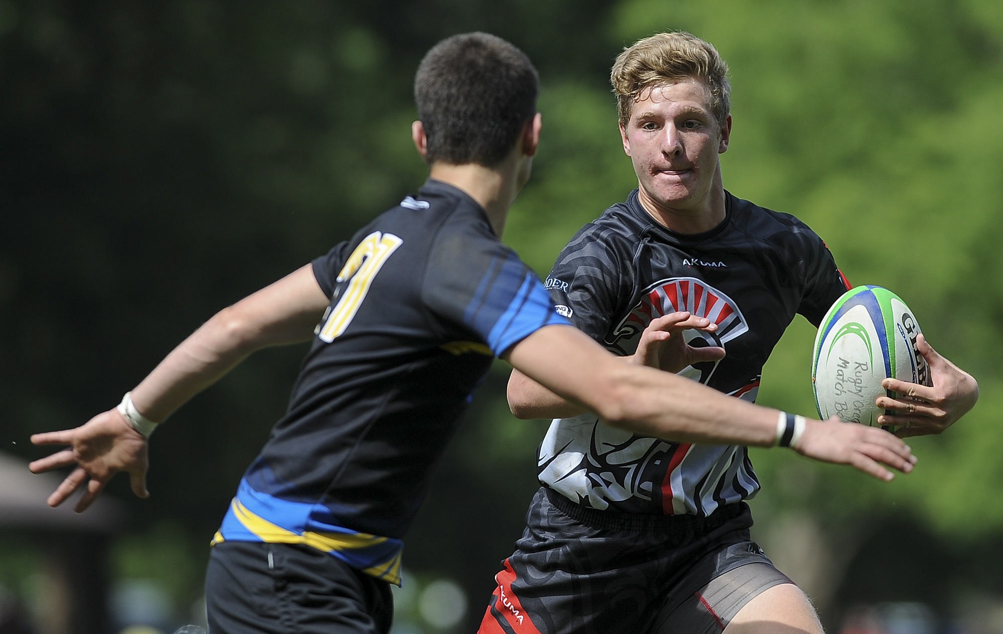 Brendon Curle of Union tries to thwart a Newberg player from gaining control of the ball in the Rugby Oregon Varsity Premiership state championship game in Portland on Saturday, May 30, 2015.