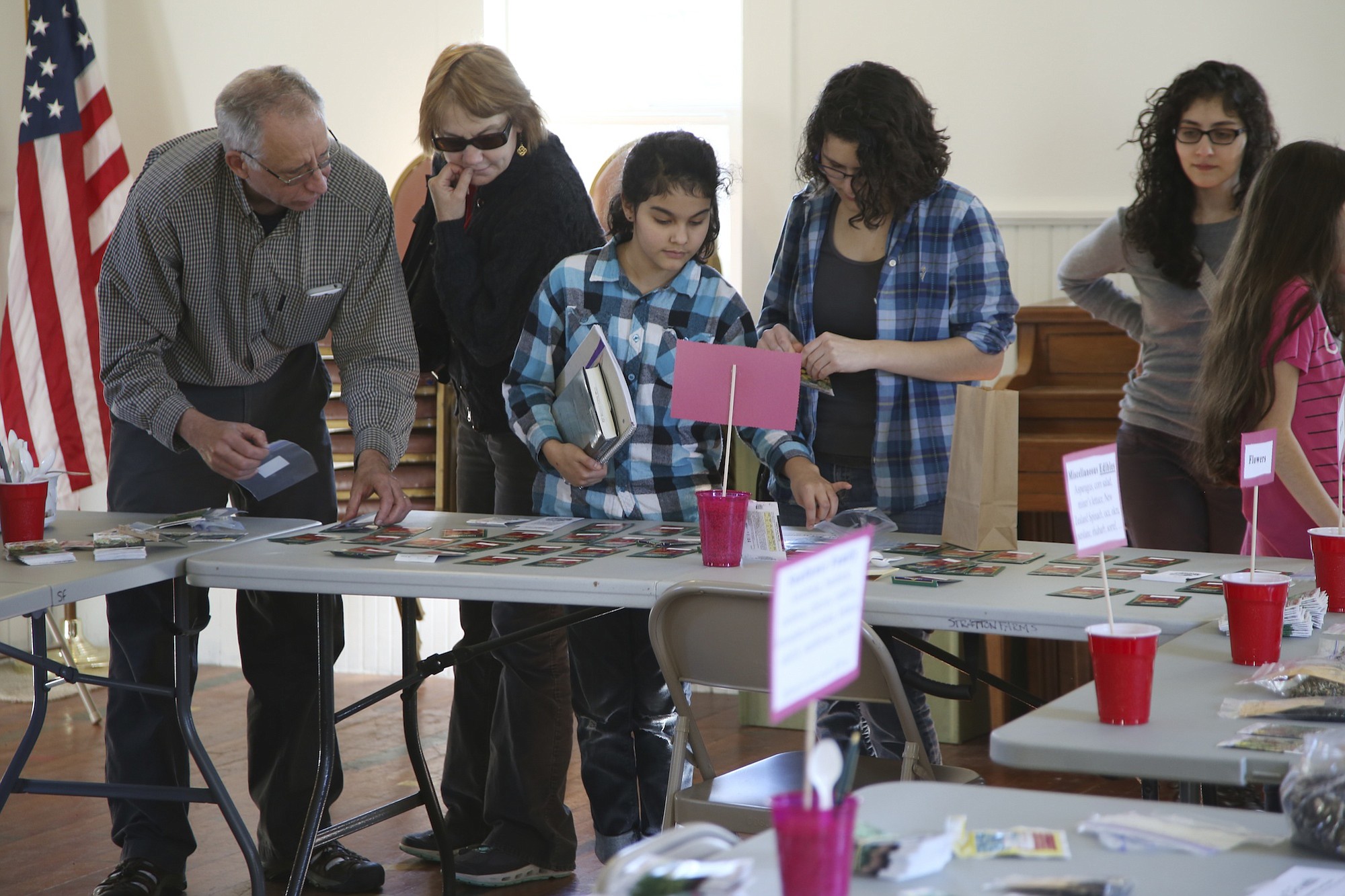 Local gardeners explore the wide range of seeds -- more than a million -- available Saturday at the first Great Clark County Seed Swap at the La Center Grange.