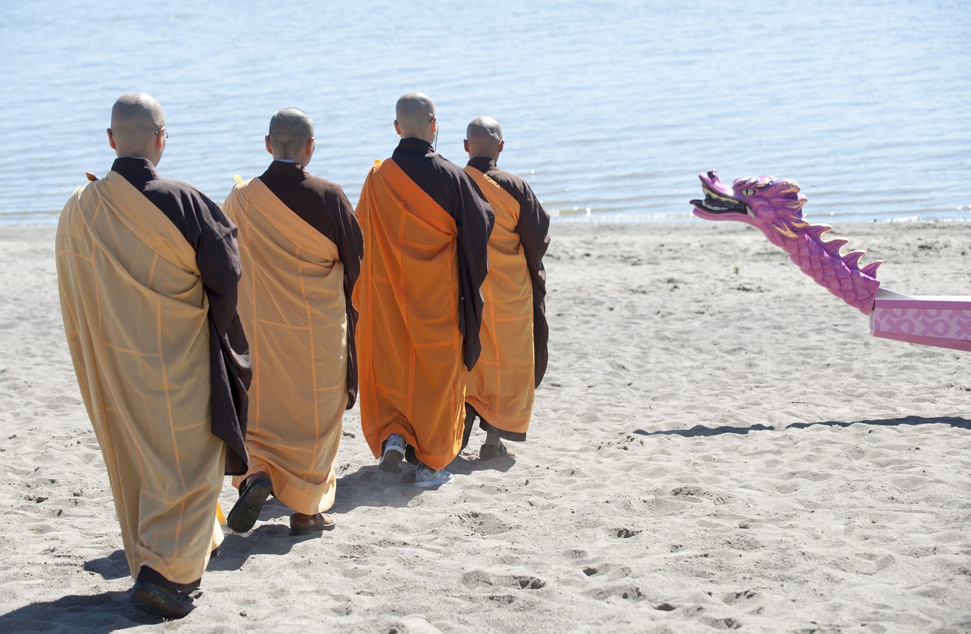 Buddhist monks from the Chu Lin Zen Temple bless the new PeaceHealth Kearney Breast Center dragon boat at Vancouver Lake on Thursday morning.