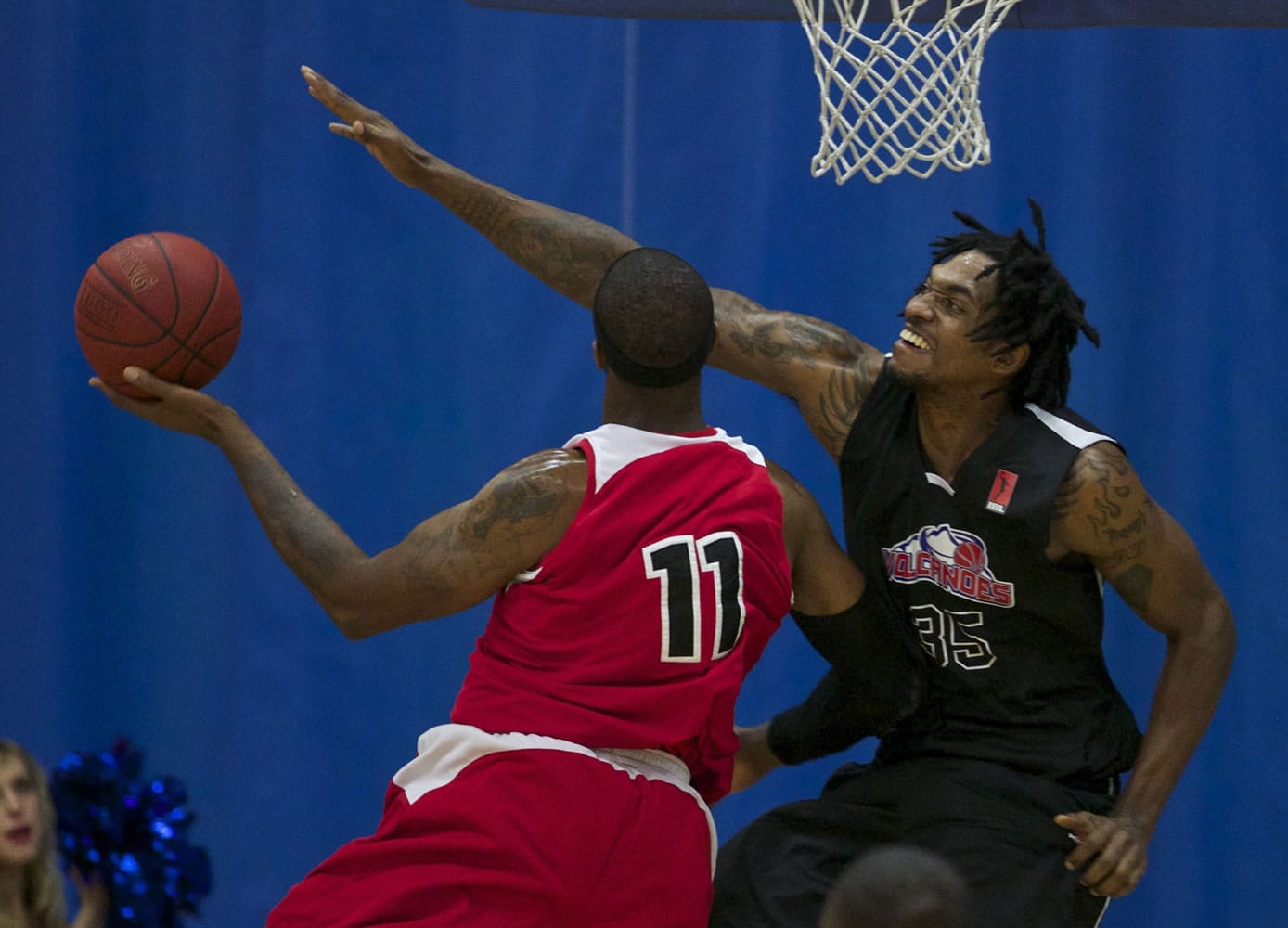 Vancouver Volcanoes center Gjio Bain (R) defends against Portland Chinooks forward Kevin Ford (L).