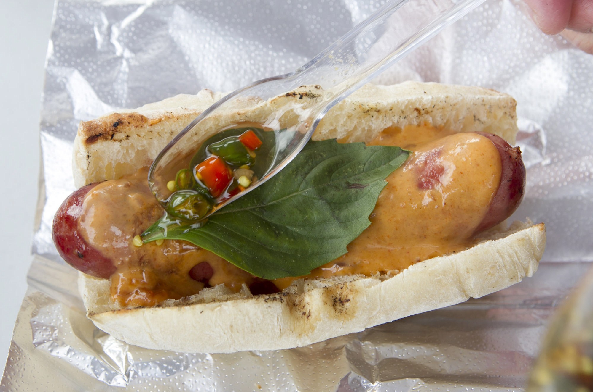 A Thai Curry Dog with penang curry, Thai basil and a homemade chili sauce is served Feb. 10 at The Nomad food cart in Vancouver.