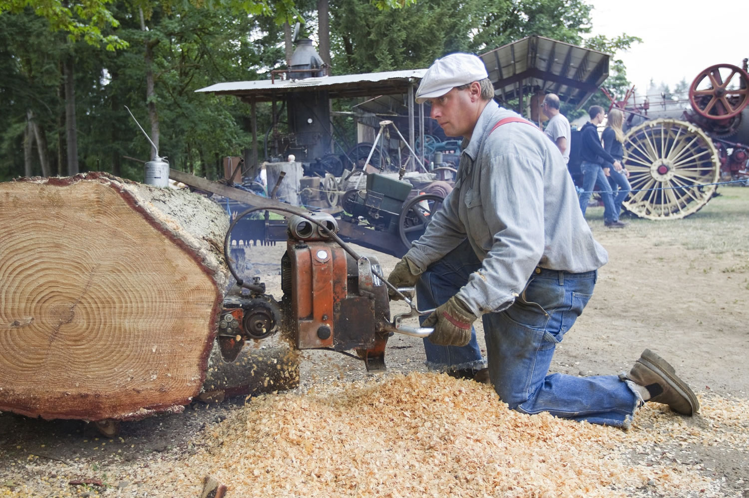 Charlie Davis uses a 1947 Mercury chainsaw at the Rural Heritage Fair in Ridgefield, Sunday July 20, 2014.  The event hosted by the Fort Vancouver Antique Equipment Association, showcases the tools used in Clark County during the 19th and 20th centuries.