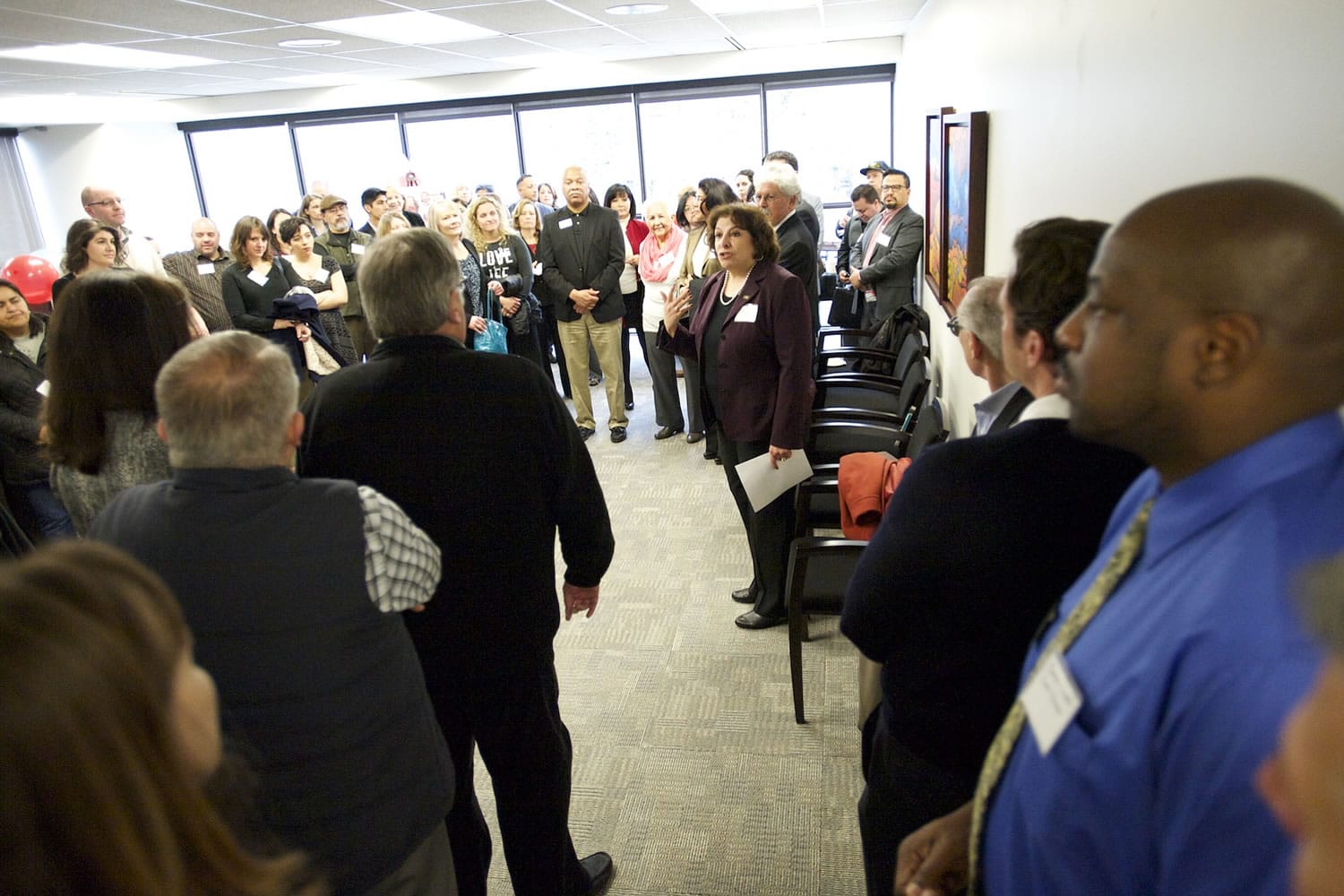 Gale Castillo, center, president of the Portland-based Hispanic Metropolitan Chamber, welcomes guests at an open house for the chamber's new office in the 805 Broadway Building in downtown Vancouver.