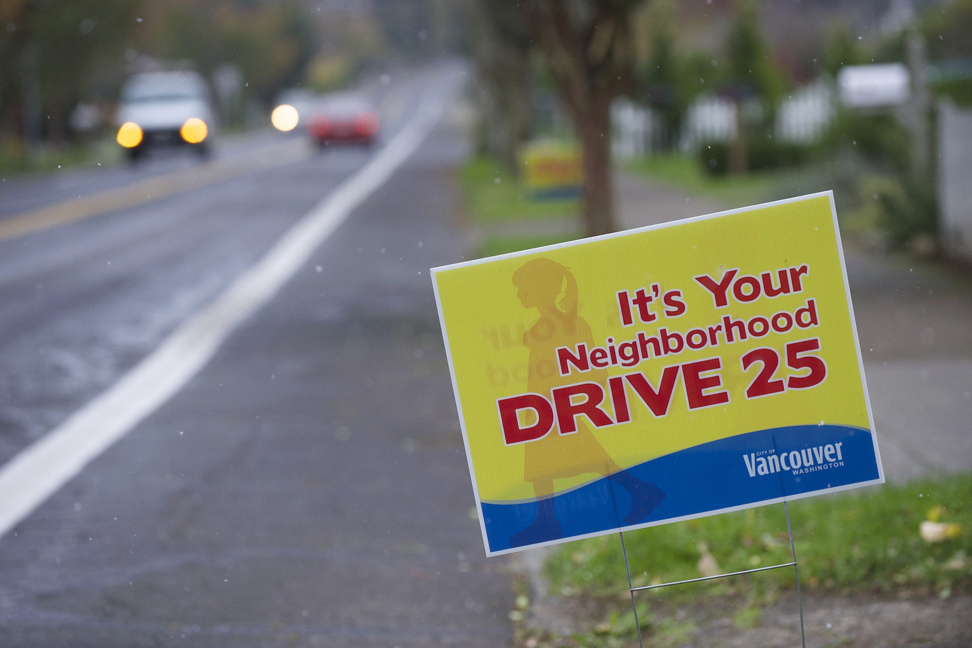 Yard signs reminding drivers to obey speed limits dot East Evergreen Boulevard, east of Harney Elementary School, in Vancouver.