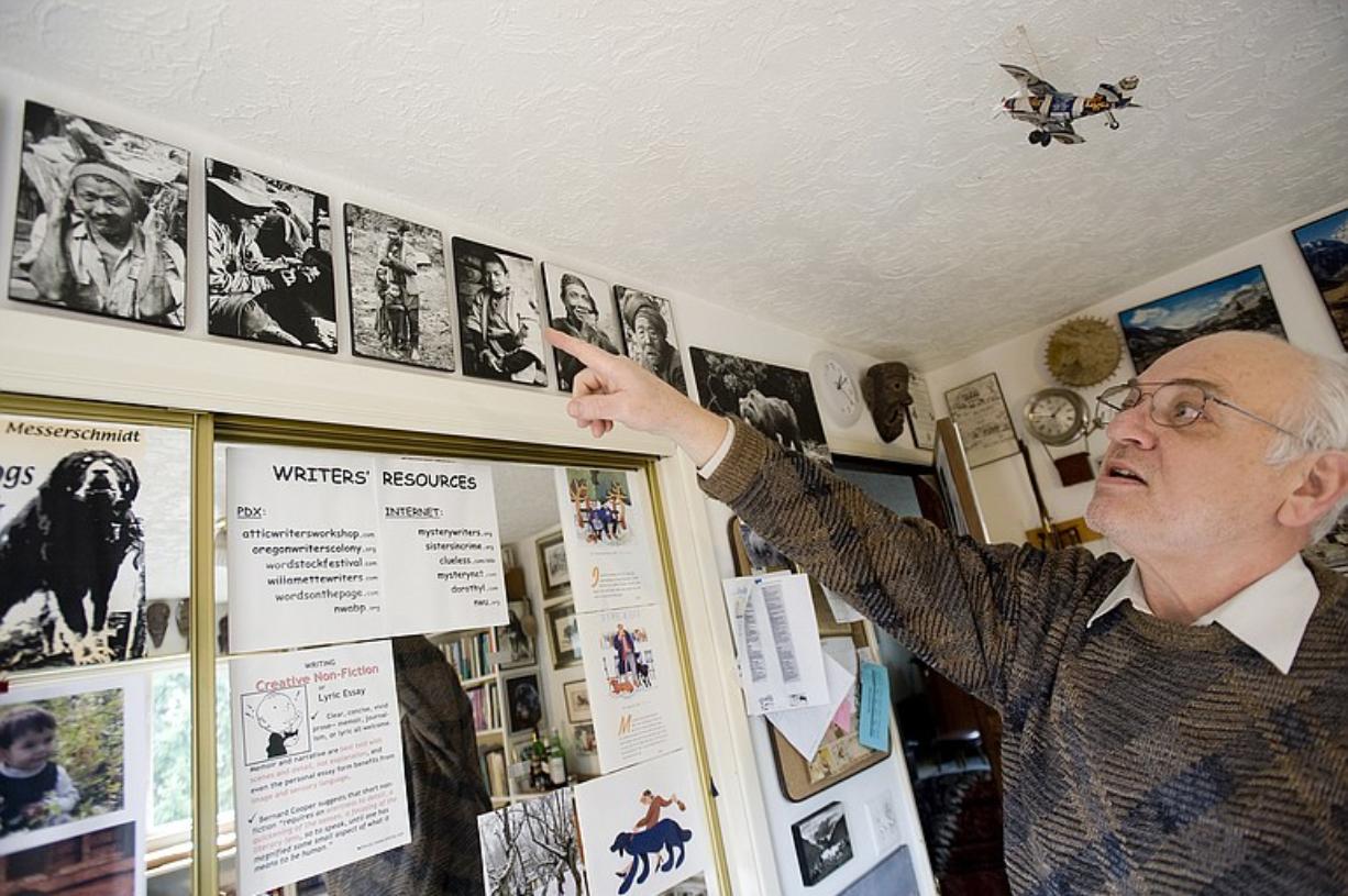 Don Messerschmidt, shown in his home office, points to photographs he took while serving in the Peace Corps in Nepal in 1963.