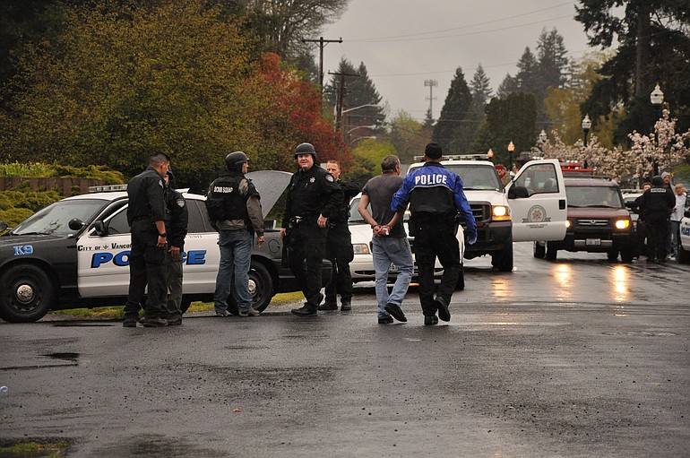 Police officers in Battle Ground lead away Randle Paul Jones, 50, of Battle Ground after an incident at 202 S.W. 4th St.