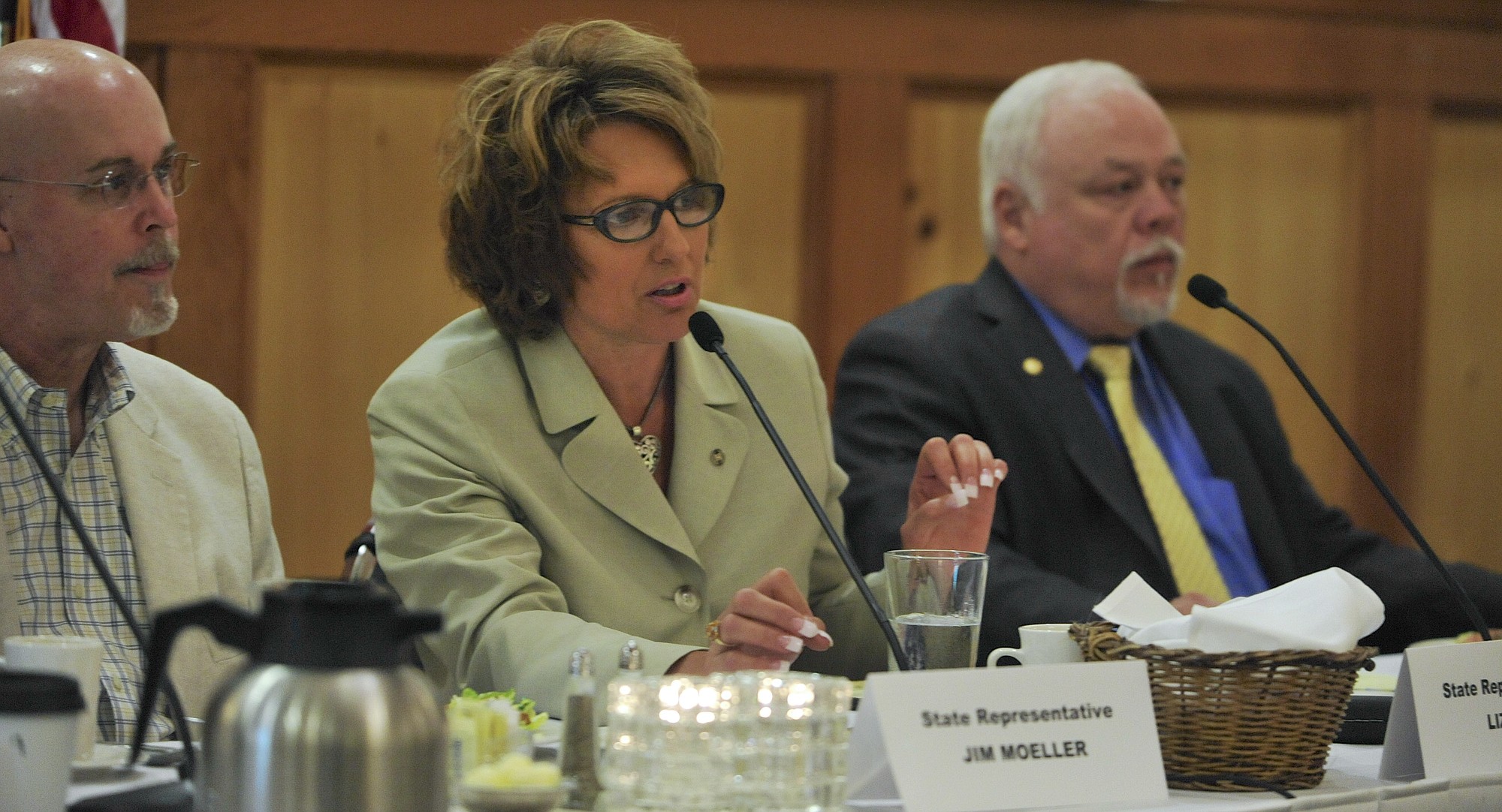 Rep. Liz Pike, R-Camas, center, speaks to lawmakers at a legislative review luncheon at the Heathman Lodge in Vancouver on Tuesday. Flanking Pike are Rep. Jim Moeller, D-Vancouver, left, and Sen.