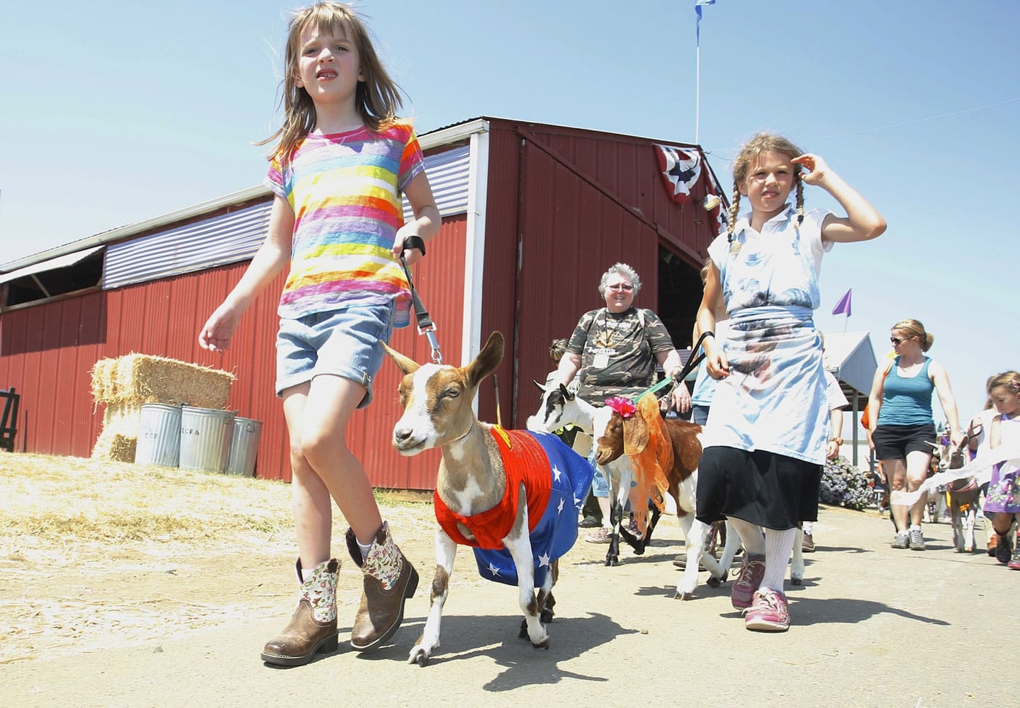 Photos by Steve Dipaola for The Columbian
Aedra Hausrath, 7, leads Justice, a miniature Nigerian dwarf goat, in a goat dress-up parade Sunday at the Clark County Fair.