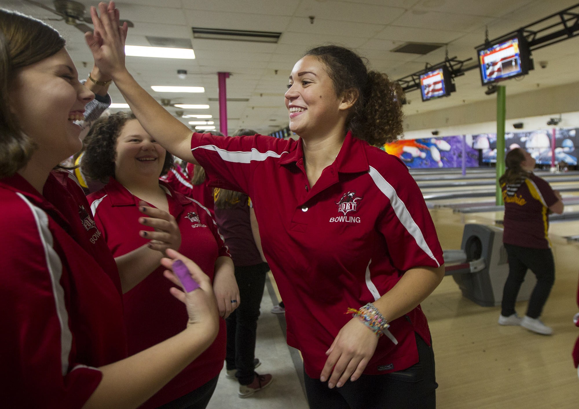 Fort Vancouver High School senior Tamika Taylor high-fives her teammates after bowling in the baker game against Prairie on Monday.