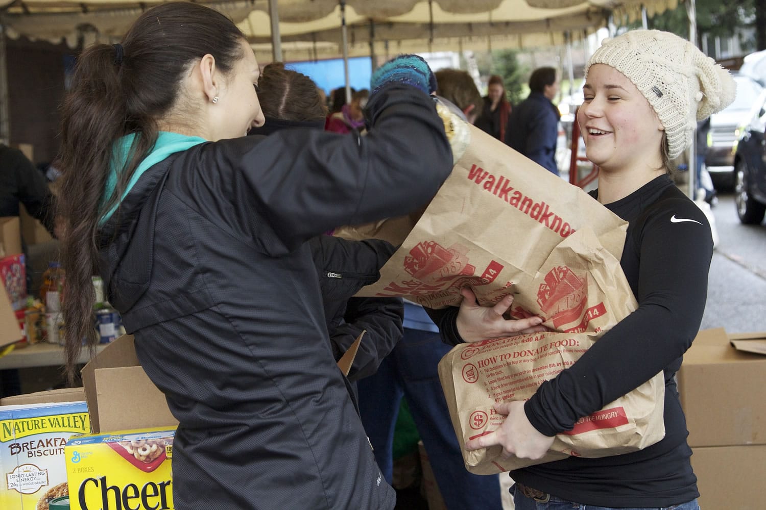 Megan Waller, 18, right, hands off bags of items donated for the 28th annual Walk