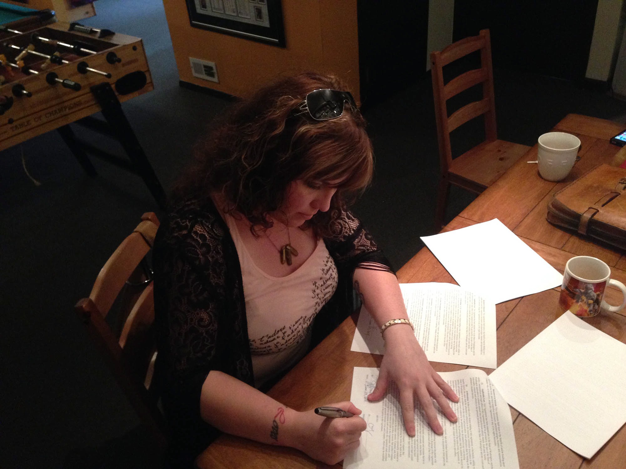 Amber Sweeney signs her new recording contract in late June at London Bridge Studios in Seattle.