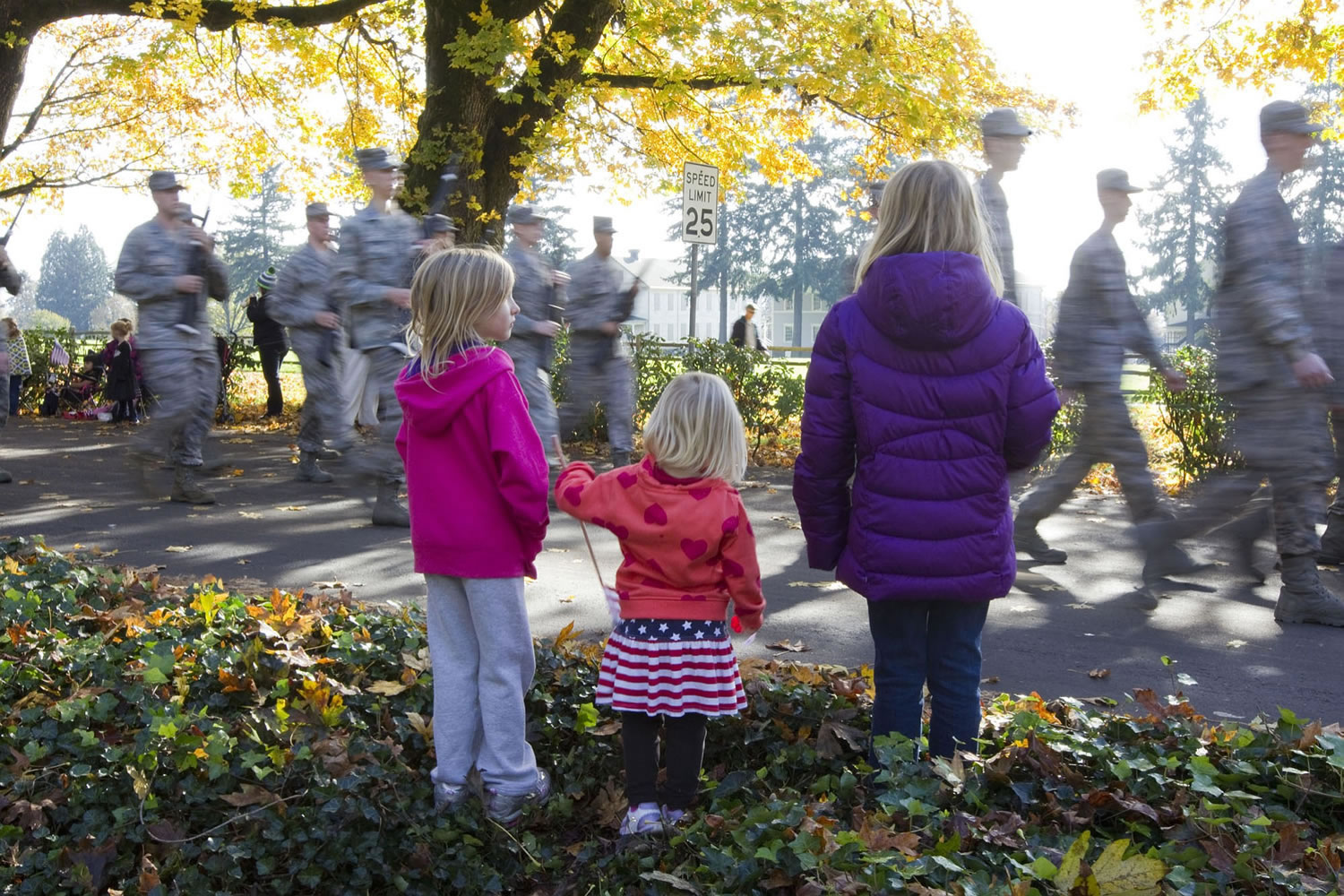 Children stand along Officers Row during Saturday's Lough Legacy Veterans Parade at Fort Vancouver.