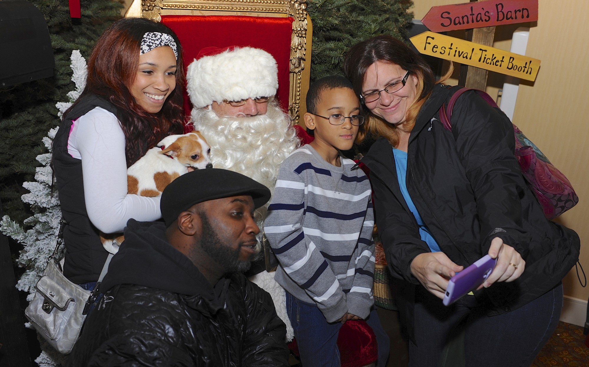 Festival of Trees
Photos by Greg Wahl-Stephens for The Columbian
Shelli Blake, right, works on getting a selfie of the family including Robert Blake, bottom left, Cash? Blake, left, with her dog Peewee and Trevon Blake as they visit with Santa at the Festival of Trees at the Hilton Vancouver Washington in downtown.