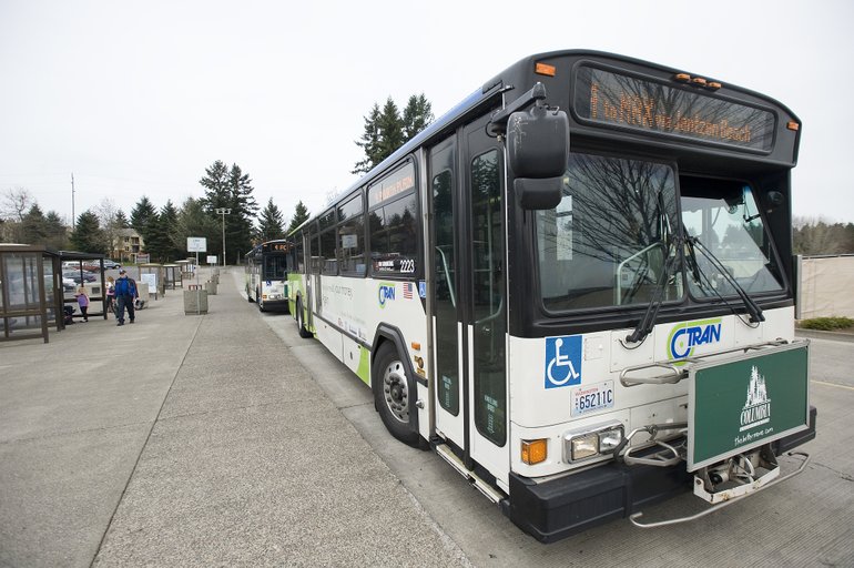Passangers wait to board a C-Tran bus April 20 at the Vancouver Mall Transit Center.